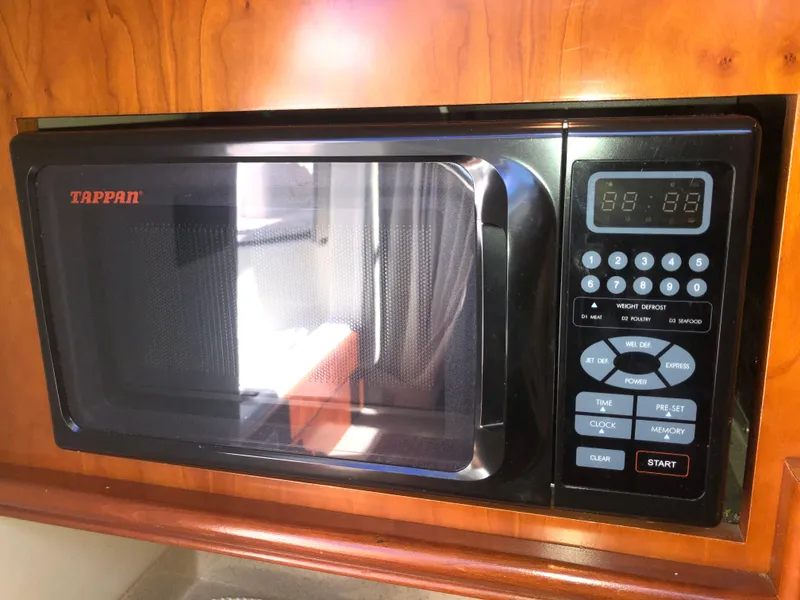 Slide: The Image of Tappan microwave in 2007 Cruisers Yachts 340 Express, set in wooden cabinetry. - 35