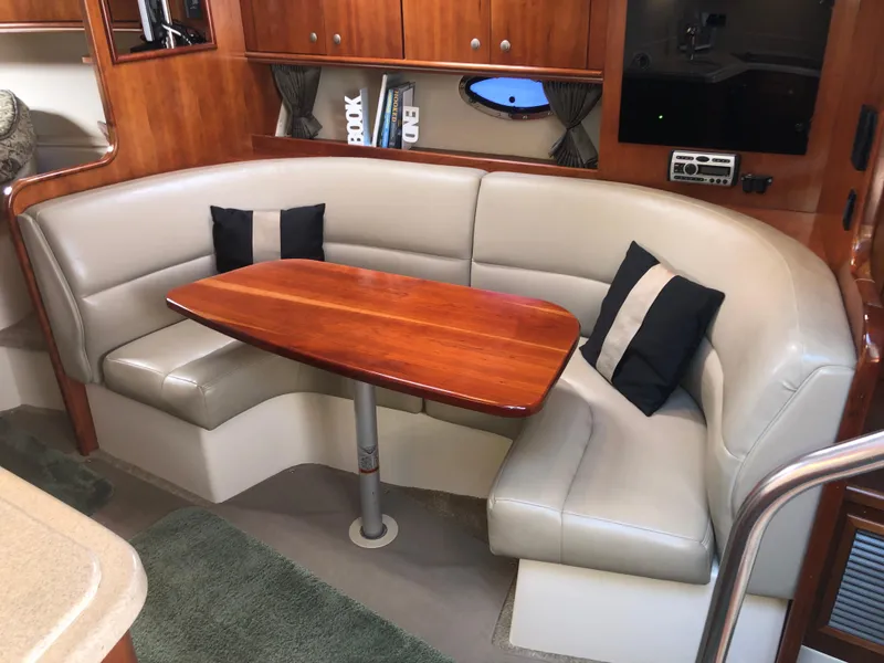 Slide: The Image of 2007 Cruisers Yachts 340 Express interior with leather seating and wooden table. - 37