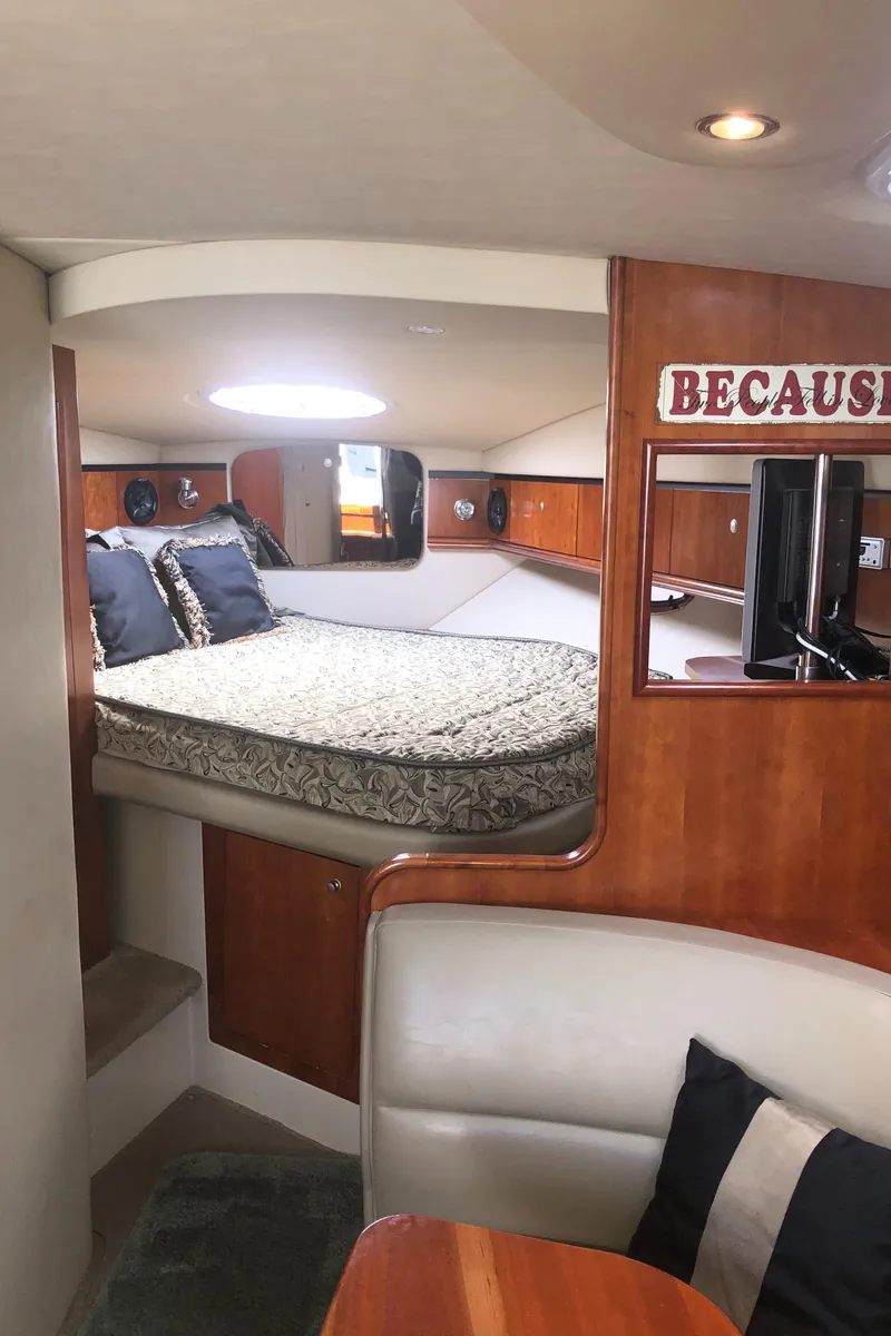Slide: The Image of 2007 Cruisers Yachts 340 Express interior with cozy bed and elegant wood finish. - 39