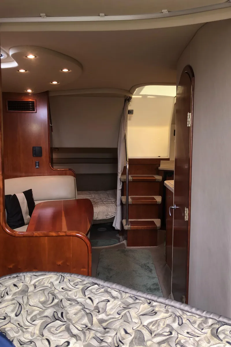 Slide: The Image of Interior of 2007 Cruisers Yachts 340 Express, featuring cozy seating and elegant wood finishes. - 43