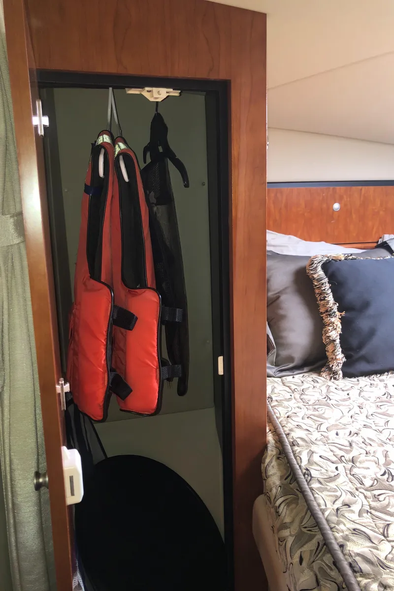 Slide: The Image of 2007 Cruisers Yachts 340 Express cabin with life jackets and bed. - 45