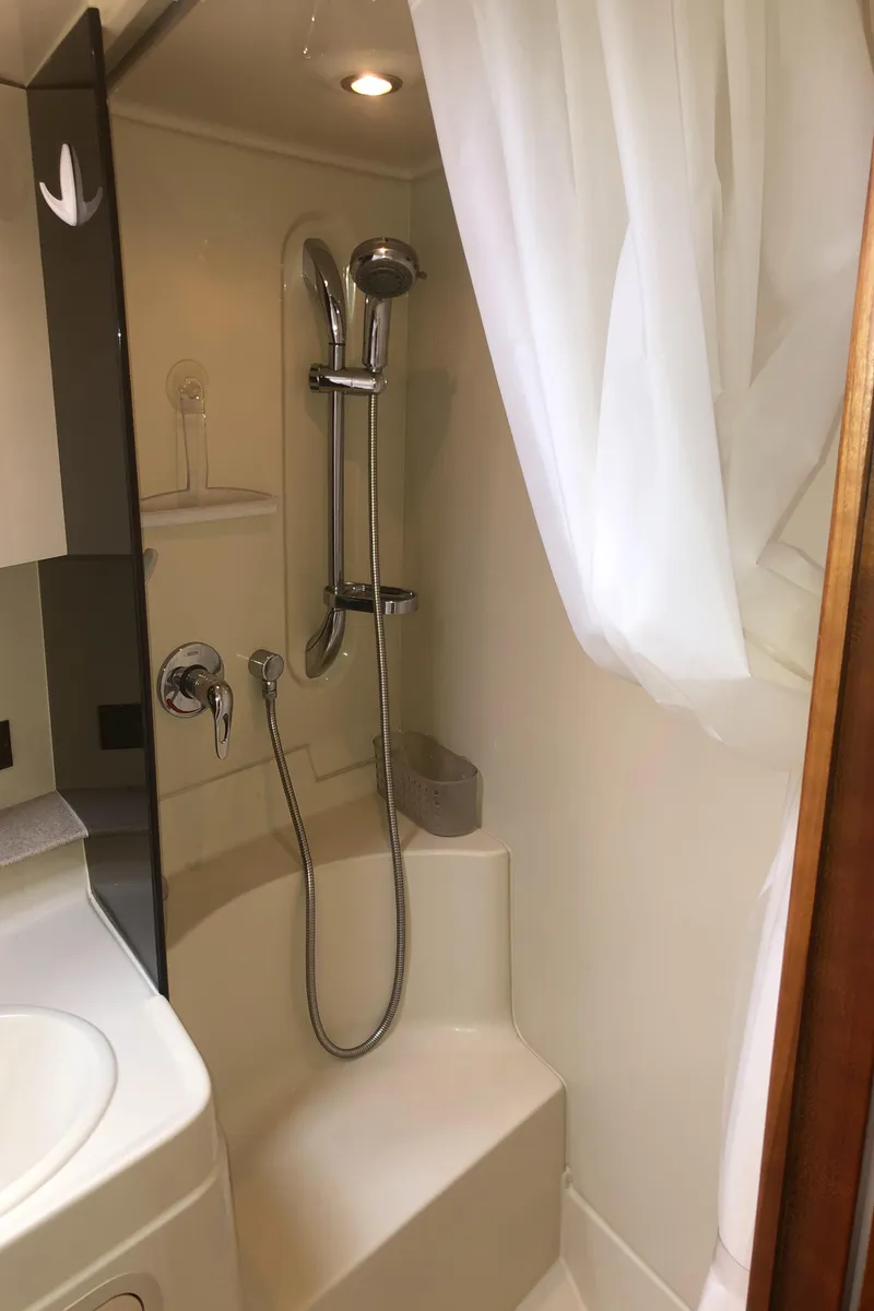 Slide: The Image of 2007 Cruisers Yachts 340 Express bathroom with shower and white curtain. - 49