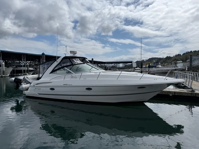 Slide: The Image of 2007 Cruisers Yachts 340 Express docked at marina under cloudy sky. - 5