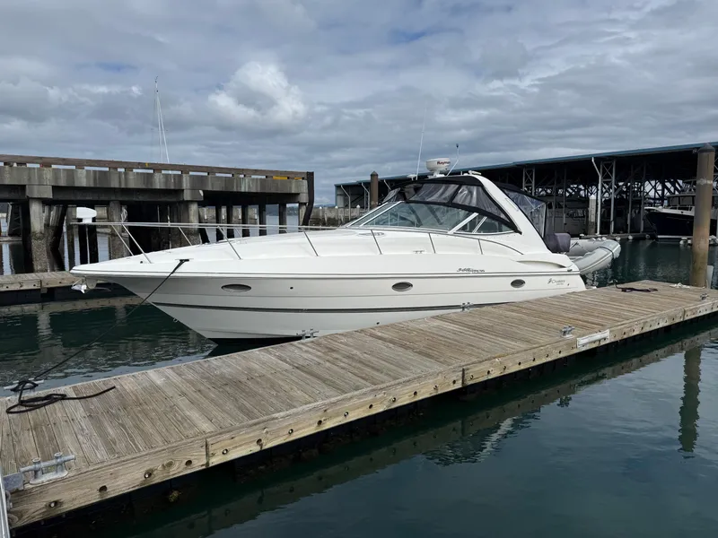 Slide: The Image of 2007 Cruisers Yachts 340 Express docked at marina under cloudy sky. - 6