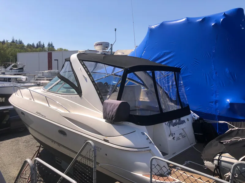 Slide: The Image of 2007 Cruisers Yachts 340 Express docked, featuring sleek design and covered cockpit. - 7