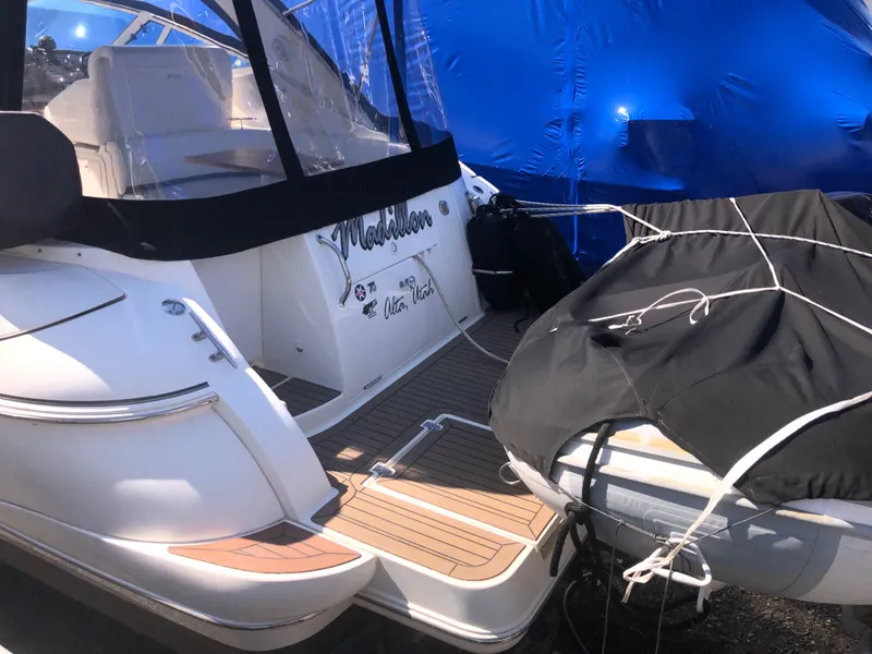 Slide: The Image of 2007 Cruisers Yachts 340 Express with covered deck and inflatable boat, docked. - 8