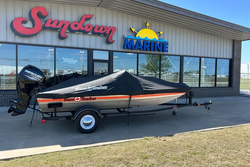 Slide: The Image of 2018 Bass Tracker Heritage boat covered, parked outside Sundown Marine dealership. - 12