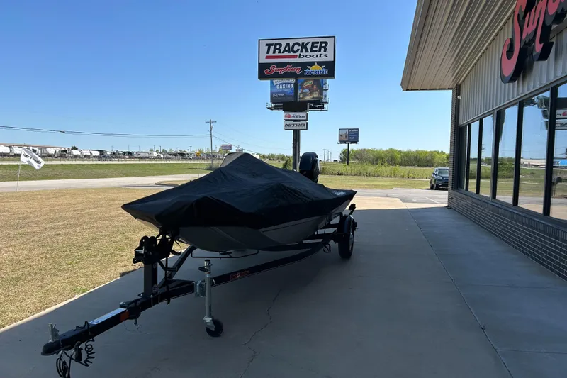 Slide: The Image of 2018 Bass Tracker Heritage boat on trailer outside dealership, covered and ready for transport. - 13