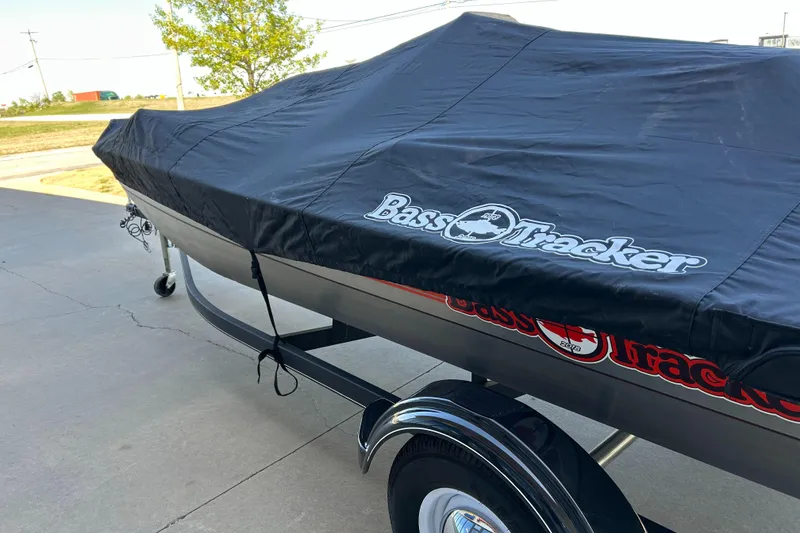 Slide: The Image of 2018 Bass Tracker Heritage boat with cover on trailer, parked outdoors. - 15