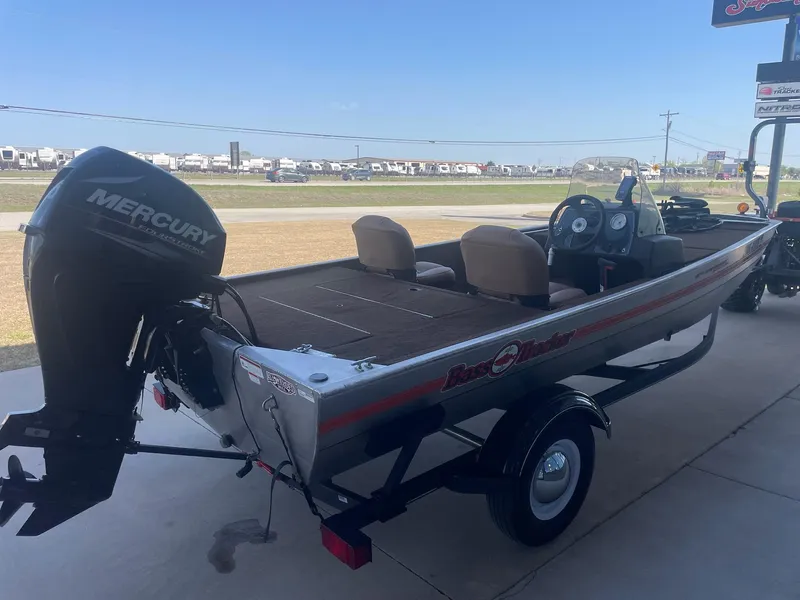 Slide: The Image of 2018 Bass Tracker Heritage boat with Mercury engine, parked outdoors. - 3