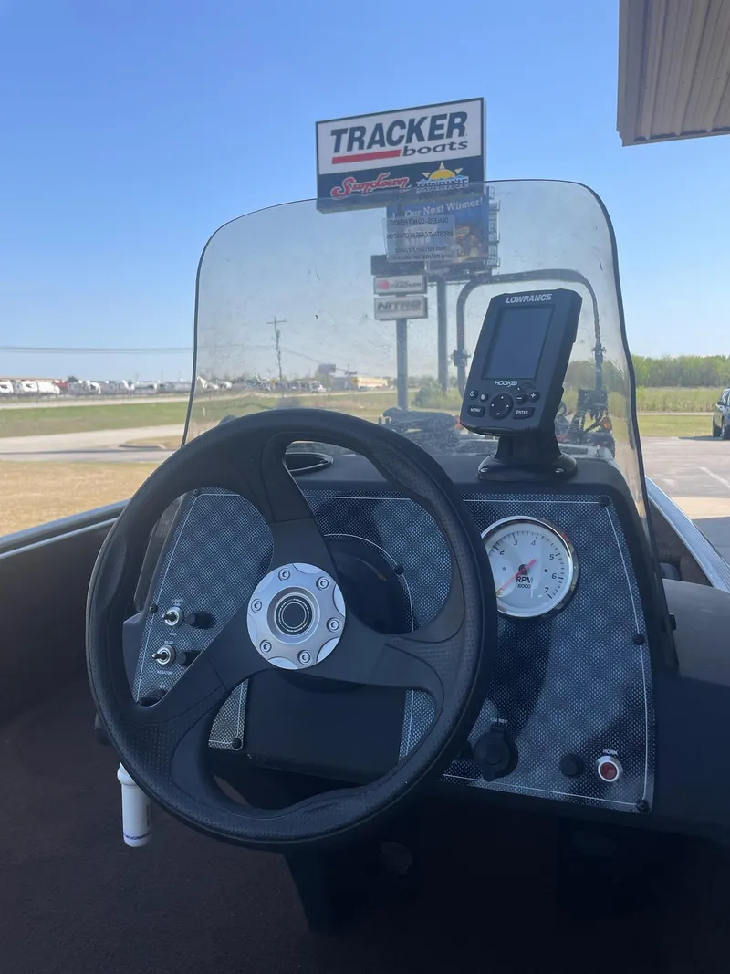 Slide: The Image of 2018 Bass Tracker Heritage boat dashboard with steering wheel and navigation display. - 8