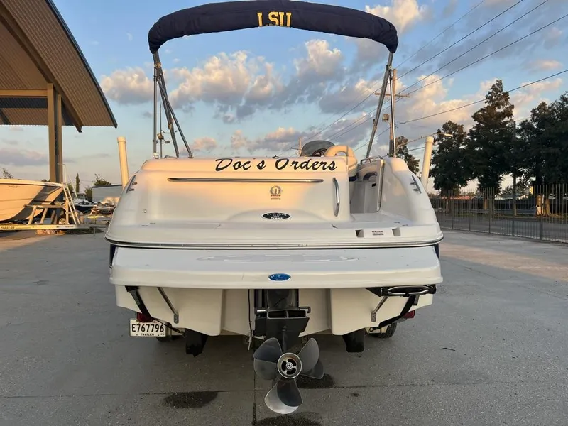 Slide: The Image of Chaparral Sunesta 252 boat, 2000 model, docked with canopy and custom name "Doc's Orders." - 10