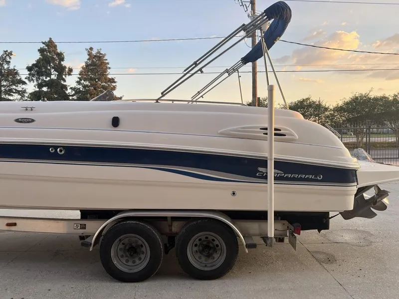 Slide: The Image of 2000 Chaparral Sunesta 252 boat on trailer, side view, outdoors at sunset. - 11