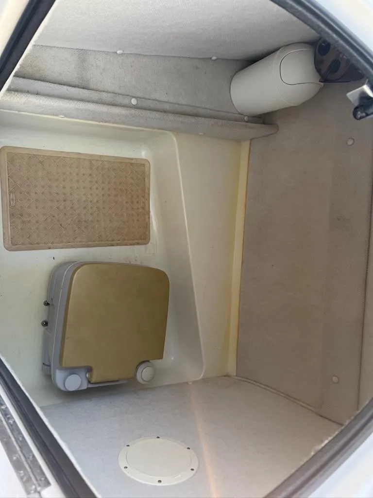 Slide: The Image of Interior cabin of 2000 Chaparral Sunesta 252 boat, featuring compact storage space. - 13