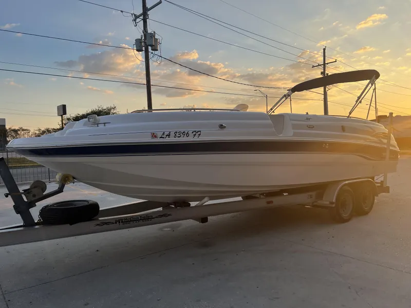 Slide: The Image of 2000 Chaparral Sunesta 252 boat on trailer at sunset, side view. - 16