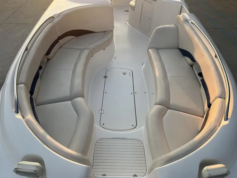 Slide: The Image of 2000 Chaparral Sunesta 252 boat interior with spacious seating and white upholstery. - 3