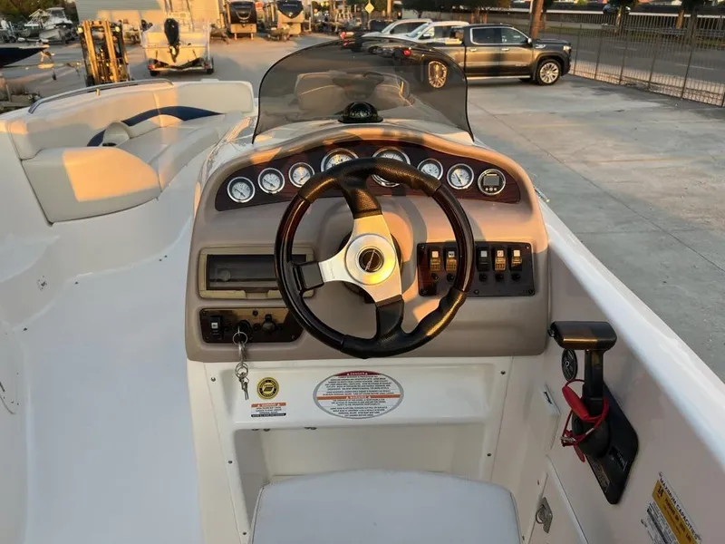 Slide: The Image of 2000 Chaparral Sunesta 252 boat dashboard with steering wheel and gauges. - 8