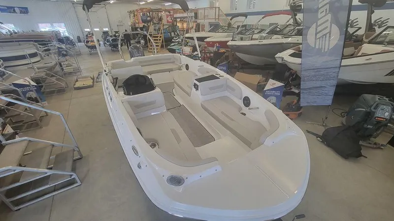 Slide: The Image of 2025 Hurricane SunDeck Sport 185 OB boat displayed in a showroom. - 3