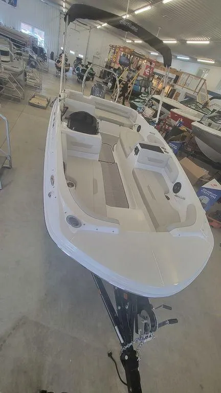 Slide: The Image of 2025 Hurricane SunDeck Sport 185 OB boat in showroom, featuring spacious seating and sleek design. - 4