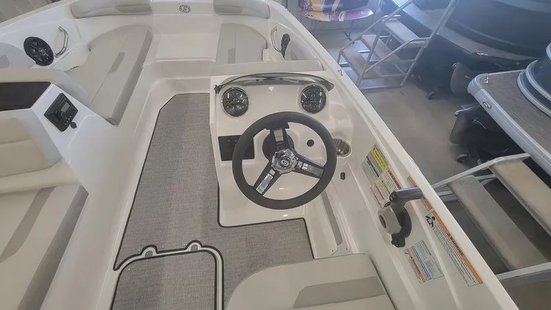 Slide: The Image of 2025 Hurricane SunDeck Sport 185 OB boat interior with steering wheel and seating. - 8