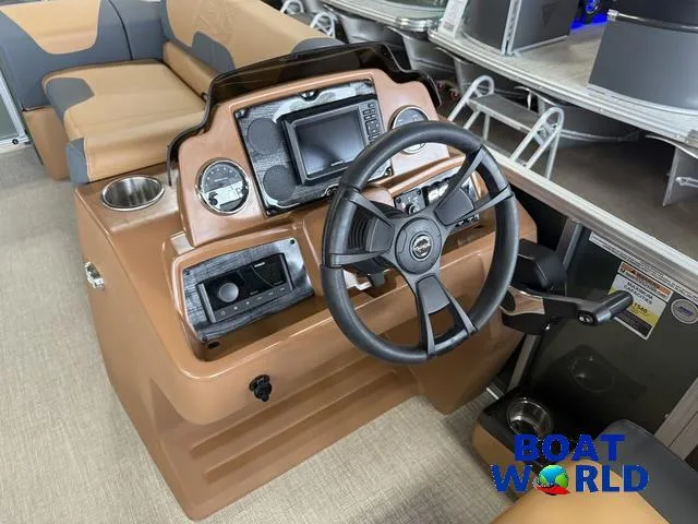 Slide: The Image of 2025 Tahoe Geofish 2385 boat dashboard with steering wheel and controls. - 13