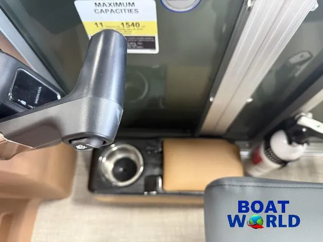 Slide: The Image of Interior of 2025 Tahoe Geofish 2385 boat with control handle and safety equipment. - 16