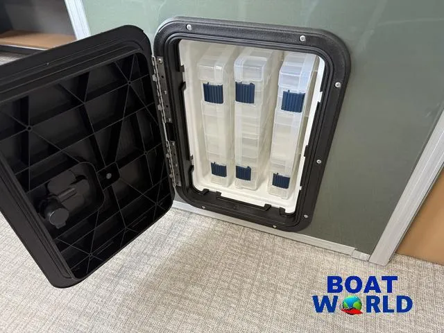 Slide: The Image of Open storage compartment with tackle boxes in a 2025 Tahoe Geofish 2385 boat. - 20