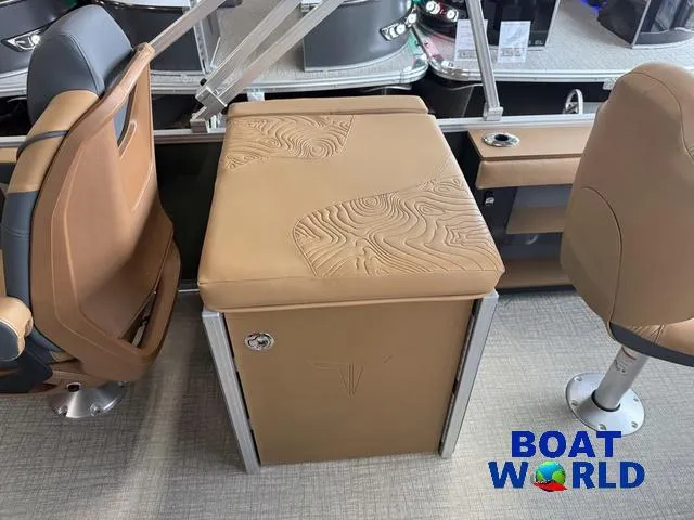 Slide: The Image of 2025 Tahoe Geofish 2385 boat interior with tan seating and embossed design. - 21