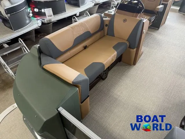 Slide: The Image of 2025 Tahoe Geofish 2385 boat interior with tan and gray seating, showcased at Boat World. - 8