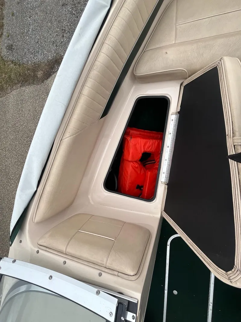 Slide: The Image of 1995 Celebrity 180 Bowrider boat interior with open storage compartment. - 13