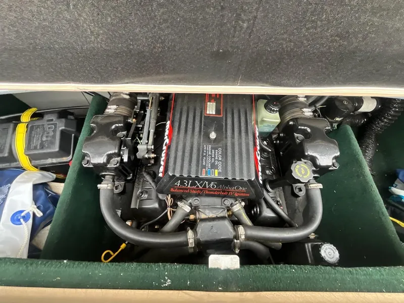 Slide: The Image of Engine compartment of a 1995 Celebrity 180 Bowrider boat, featuring a 4.3L V6 motor. - 14