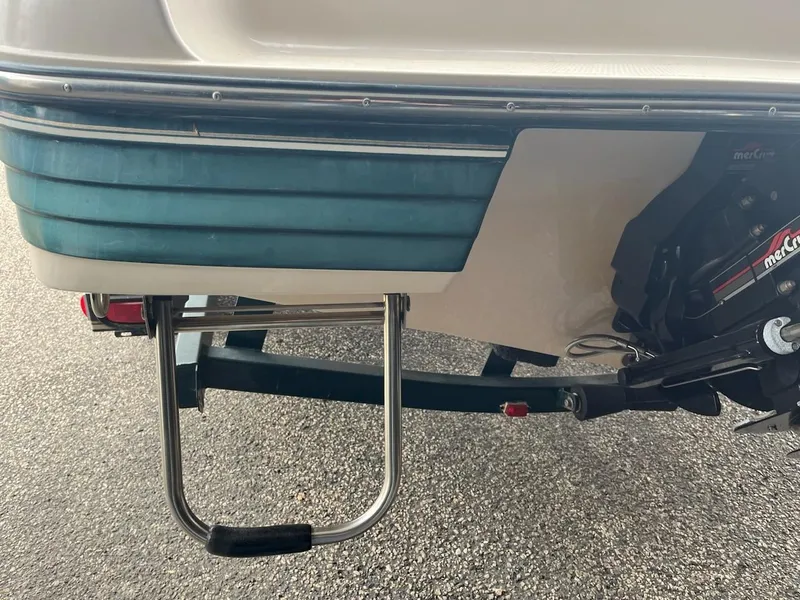 Slide: The Image of 1995 Celebrity 180 Bowrider boat stern with ladder and outboard motor. - 15