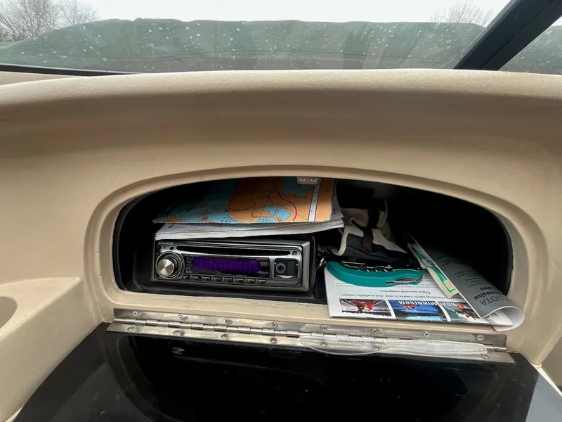 Slide: The Image of Glove compartment of 1995 Celebrity 180 Bowrider with stereo and maps. - 8