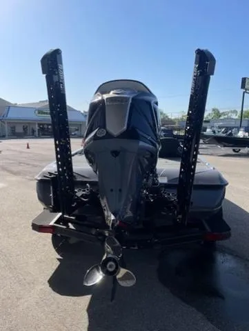 Slide: The Image of 2025 Skeeter ZXR21 boat with powerful outboard motor, parked outdoors. - 11