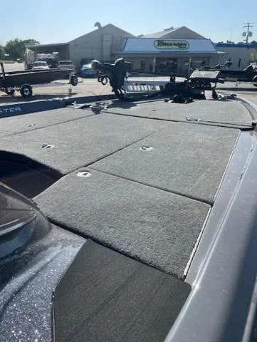 Slide: The Image of 2025 Skeeter ZXR21 boat deck with carpeted surface in a dealership lot. - 7