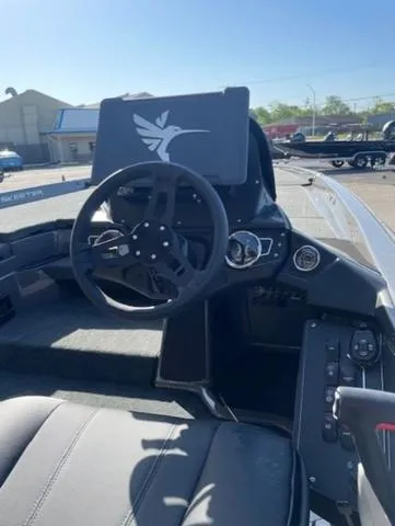 Slide: The Image of 2025 Skeeter ZXR21 boat dashboard with steering wheel and control panel. - 8