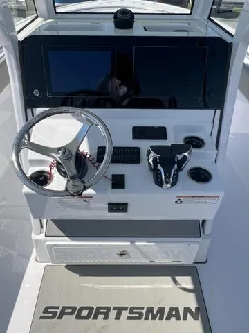 Slide: The Image of 2025 Sportsman Open 252 boat console with steering wheel and dual screens. - 10