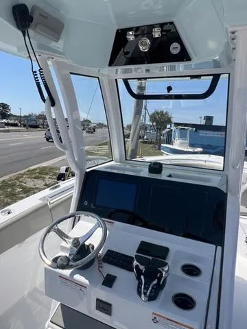 Slide: The Image of 2025 Sportsman Open 252 boat dashboard with steering wheel and controls. - 11
