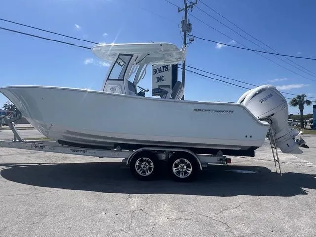 Slide: The Image of 2025 Sportsman Open 252 boat on trailer, side view, clear sky background. - 3