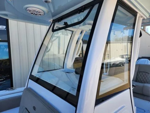 Slide: The Image of 2025 Sportsman Open 252 boat with sleek windshield design and modern interior. - 4