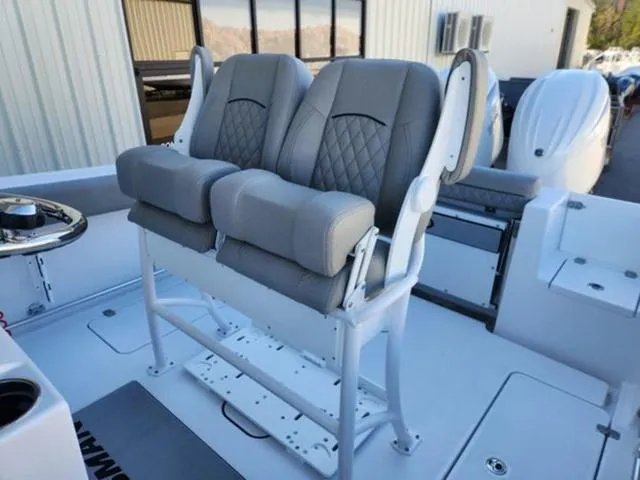 Slide: The Image of 2025 Sportsman Open 252 boat with dual cushioned seats and modern design. - 5