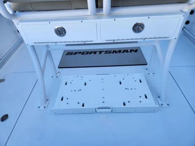 Slide: The Image of 2025 Sportsman Open 252 boat interior with storage drawers and branded mat. - 8