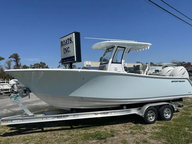 Slide: The Image of 2025 Sportsman Open 252 boat on trailer at dealership, clear sky background. - 9