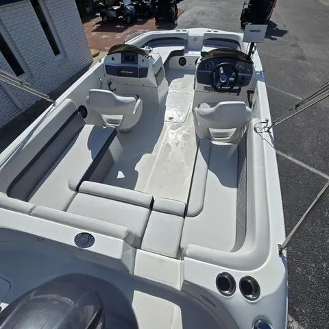 Slide: The Image of 2023 Hurricane Sundeck Sport 218 OB boat interior with seating and steering console. - 10