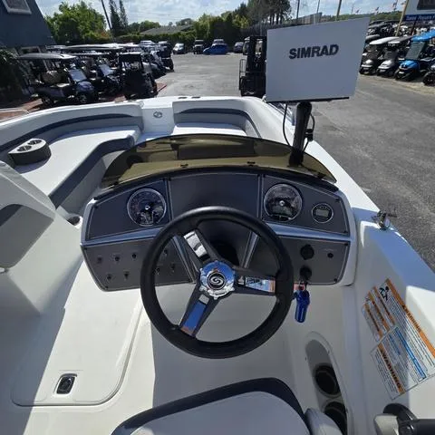 Slide: The Image of 2023 Hurricane Sundeck Sport 218 OB boat dashboard with steering wheel and Simrad display. - 11