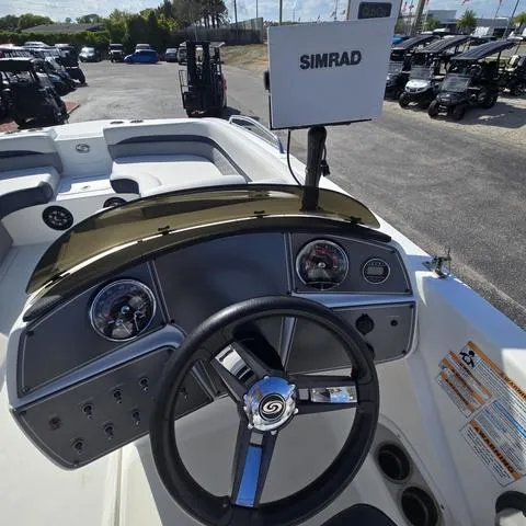 Slide: The Image of 2023 Hurricane Sundeck Sport 218 OB boat dashboard with Simrad display and steering wheel. - 15