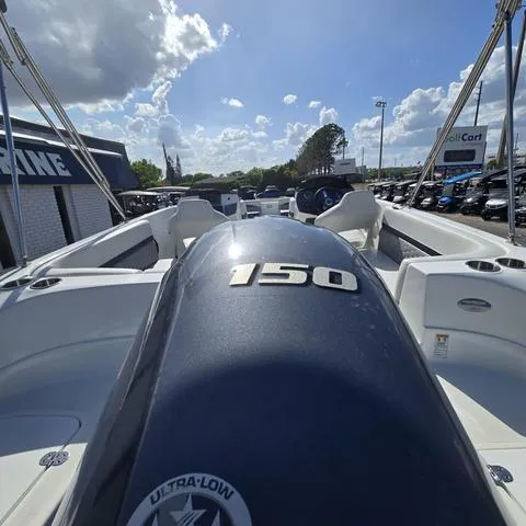 Slide: The Image of 2023 Hurricane Sundeck Sport 218 OB boat with 150 horsepower engine, under a partly cloudy sky. - 4