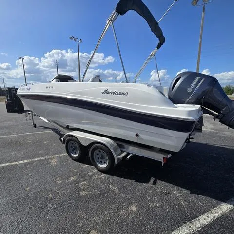 Slide: The Image of 2023 Hurricane Sundeck Sport 218 OB boat on trailer, parked outdoors under blue sky. - 5