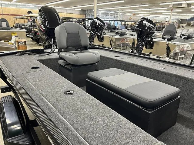 Slide: The Image of 2025 Tracker Panfish™ 17 boat interior with seating and storage, displayed in a showroom. - 3