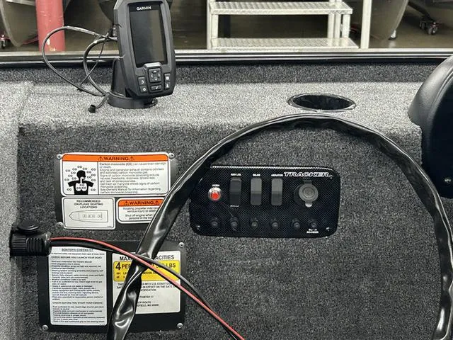Slide: The Image of 2025 Tracker Panfish™ 17 boat dashboard with Garmin device and control panel. - 8